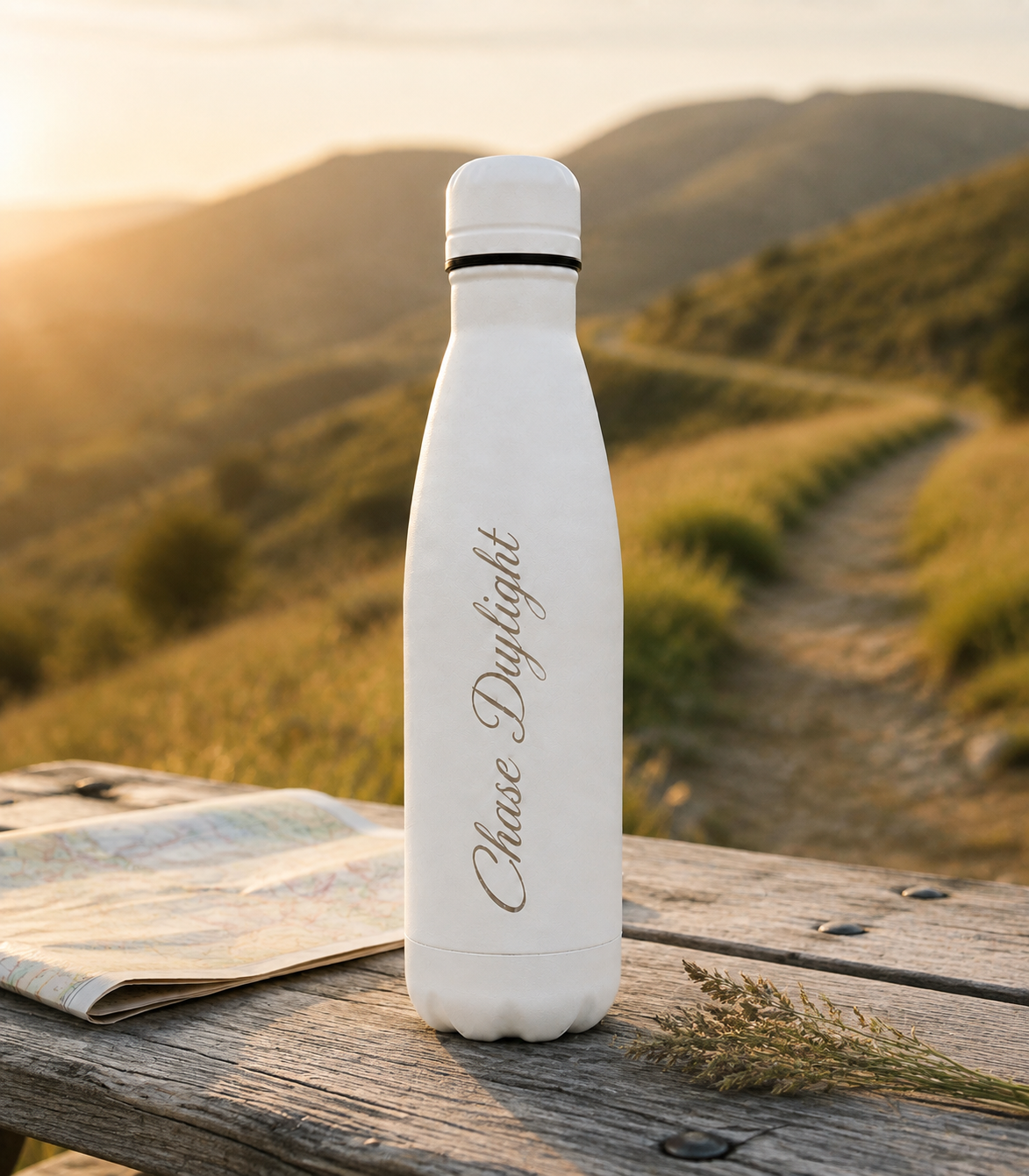 White 500ml personalised stainless steel water bottle engraved “Chase Daylight” on a mountain hiking trail with map at sunset | Willys Bottles