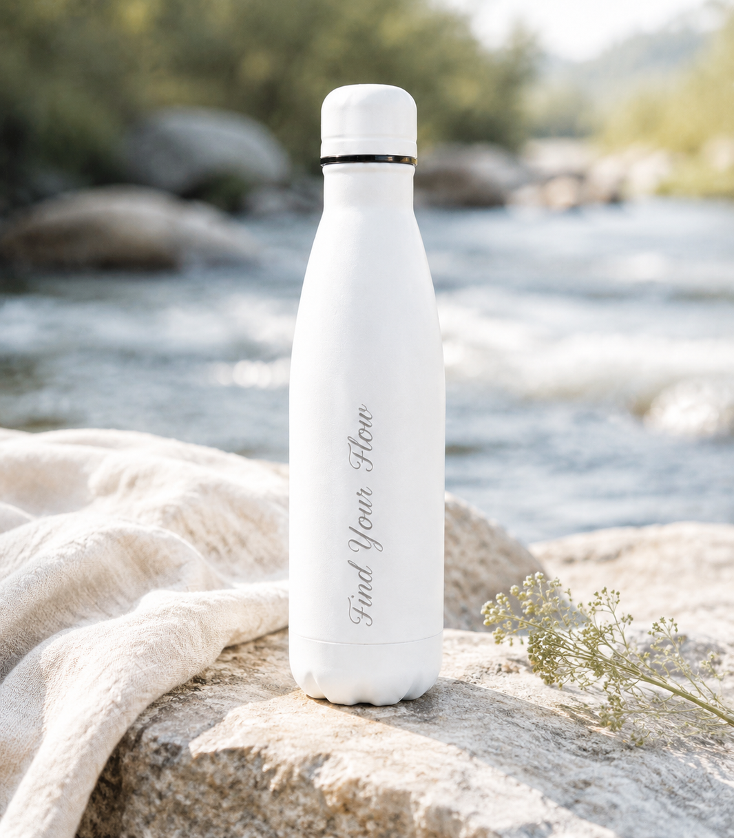 White 500ml personalised stainless steel water bottle engraved “Find Your Flow” beside a riverside with wildflowers | Willys Bottles