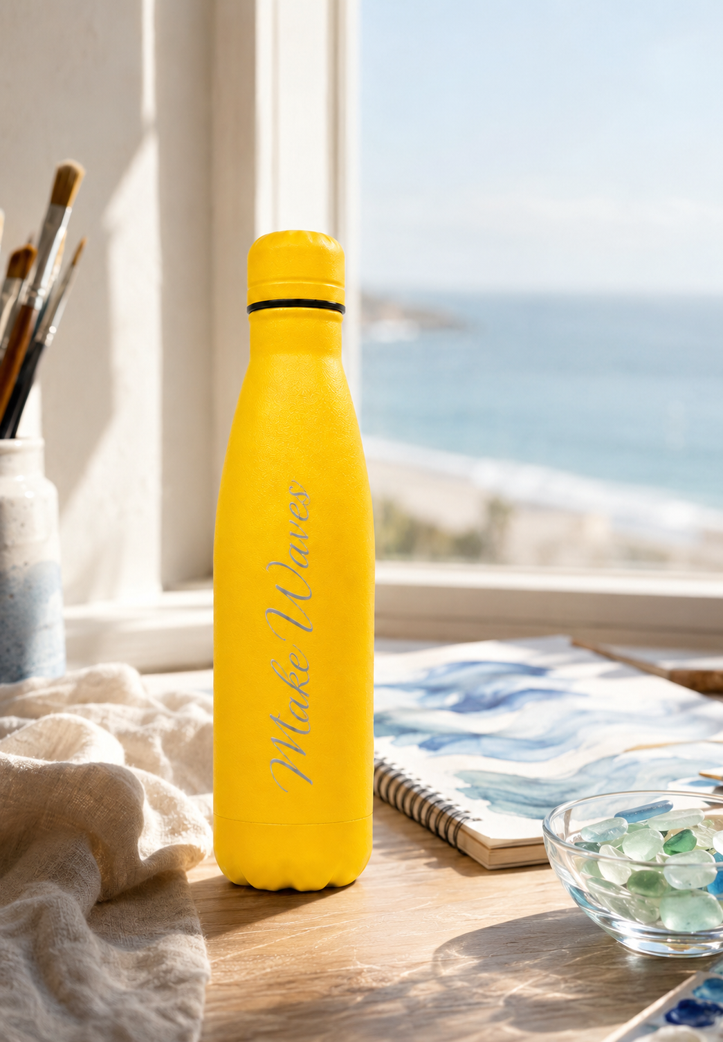 Yellow 500ml personalised stainless steel water bottle engraved “Make Waves” beside seaside artwork and sea glass | Willys Bottles